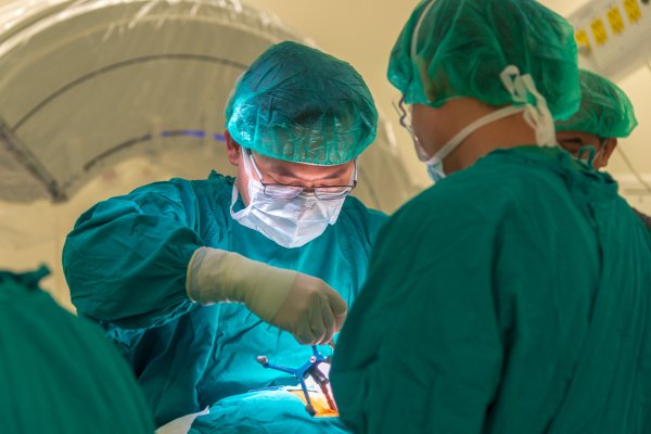 A team of experts performing open surgery for a disc-related spine issue.